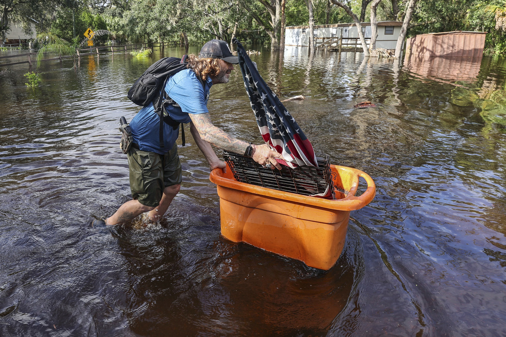 Residents slog through flooded streets, clear debris after Hurricane Milton tore through Florida Residents slog through flooded streets, clear debris after Hurricane Milton tore through Florida