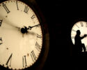 FILE - Custodian Ray Keen inspects a clock face before changing the time on the 100-year-old clock atop the Clay County Courthouse March 8, 2014, in Clay Center, Kan. (AP Photo/Charlie Riedel, File)