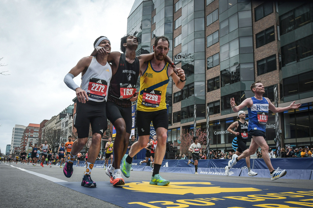 Man who helped fellow runner across Boston Marathon finish line says it was natural instinct to help