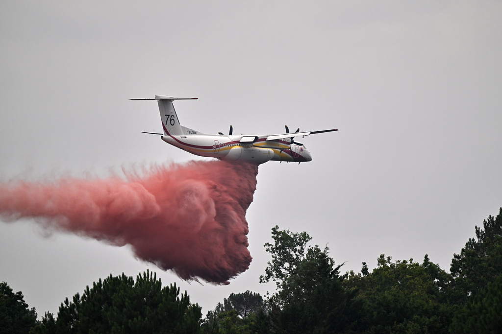 France says monster fire that forced 220,000 people to flee has stopped growing