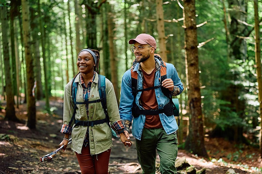 A couple hiking in a forest.